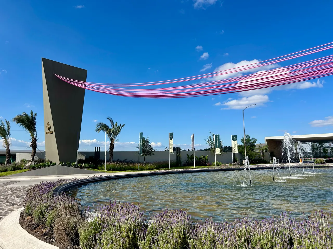 Plaza de acceso con fuente de un desarrollo Grupo Velas